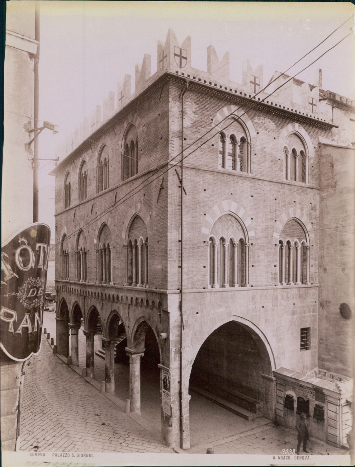 Late nineteenth-century photograph of the Palazzo San Giorgio in Genoa, the medieval seat of the Casa di San Giorgio, with its loggia and frescoed façade facing the harbour.